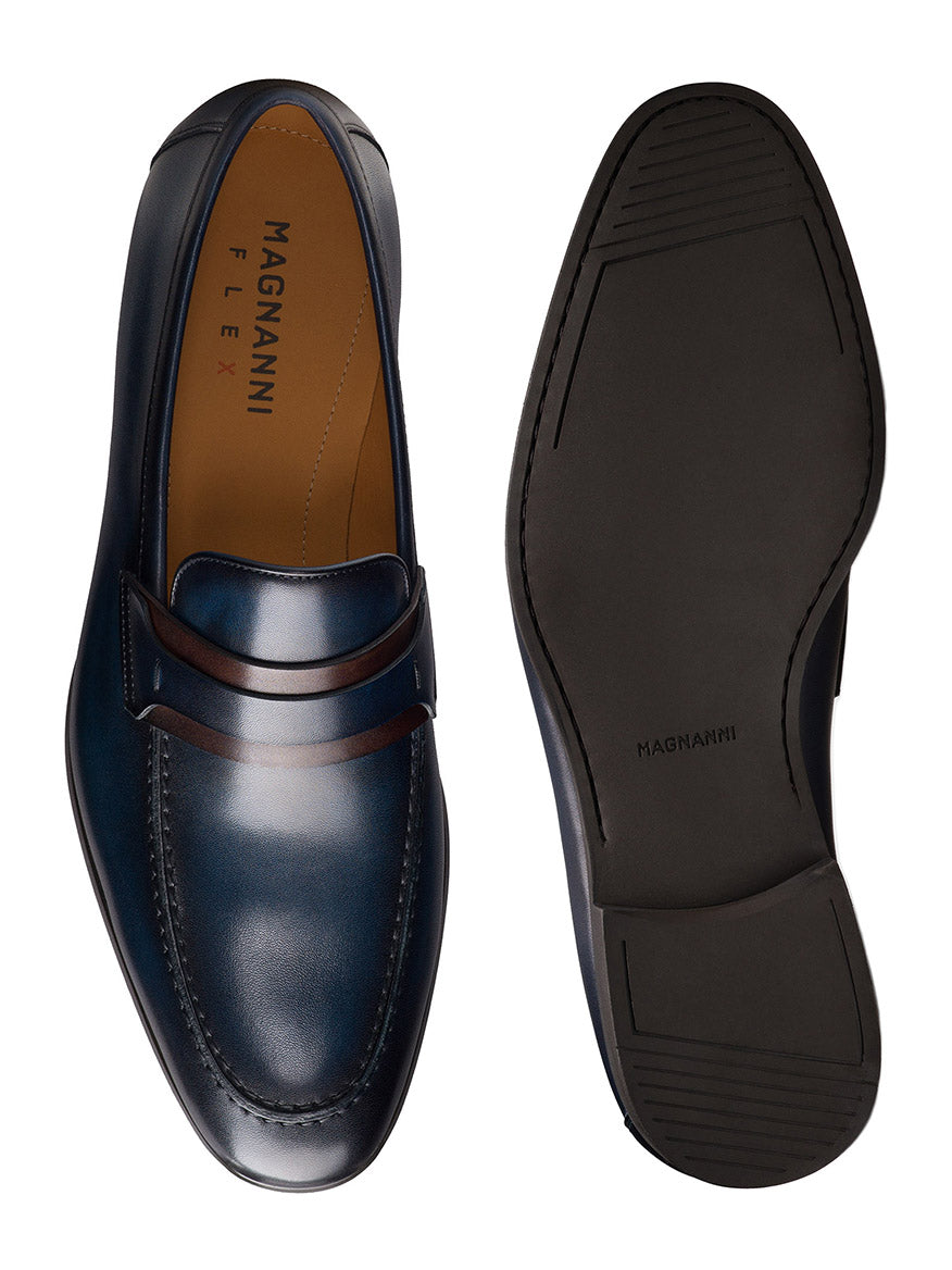 A pair of Magnanni Daniel penny loafers in Navy/Midbrown, made in Spain, shown from top and sole views.