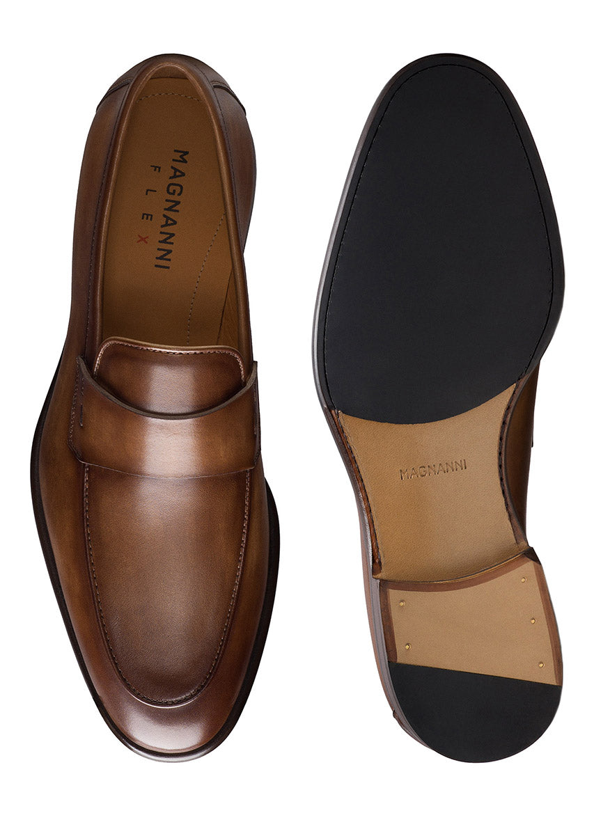 The Magnanni Duerro in Brown is a men's luxury loafer shown from top and bottom, featuring a sleek design with a penny strap, apron toe silhouette, and black rubber sole.