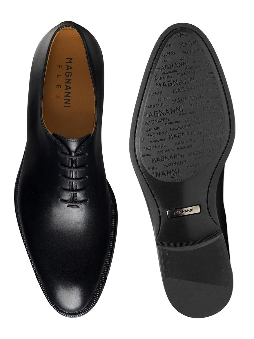 Top and bottom views of the Magnanni Hawkins in Black, a polished leather Oxford shoe featuring classic design with closed lacing on the upper and a sole imprinted repeatedly with "Magnanni.