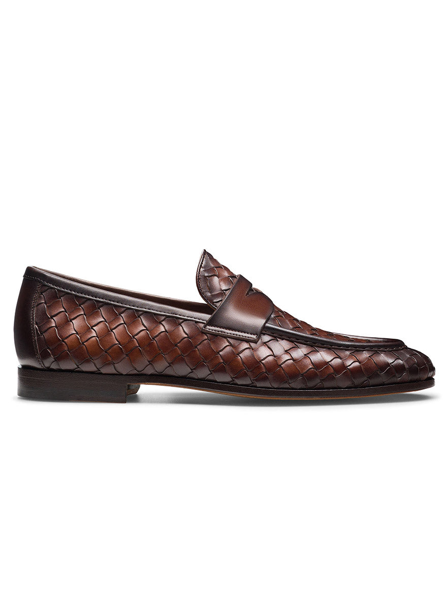 The Magnanni Hyde in Midbrown is a hand-woven penny loafer featuring a brown leather finish with a woven design and a smooth leather strap. Its Línea Flex design ensures flexibility and comfort with every step.