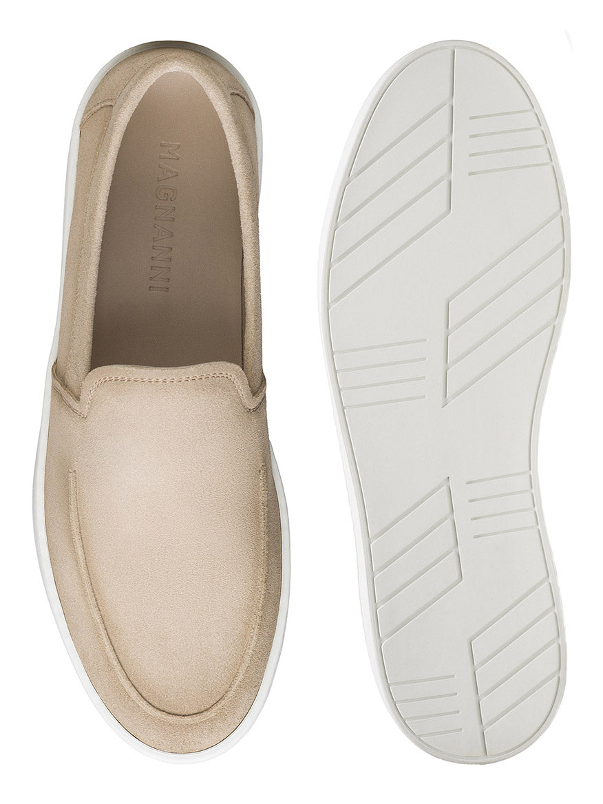 The Magnanni Lawford Venetian Flex in Tierra Suede features beige slip-on style and white rubber soles, shown from top and bottom views on a white background, highlighting Magnanni's signature comfort and style.