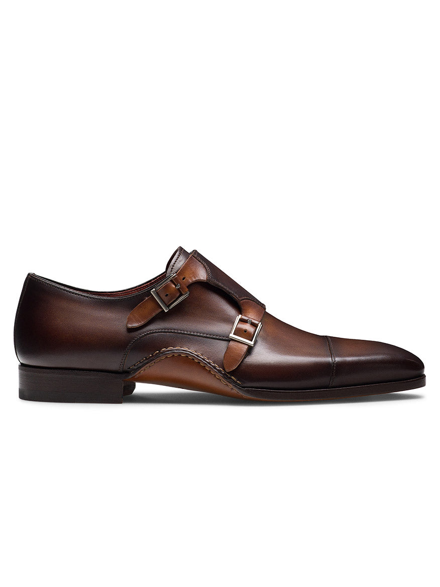 The Magnanni Leros in Tabaco/Cuero is a brown leather monk strap shoe with a double buckle design, low heel, and sleek Bologna construction.