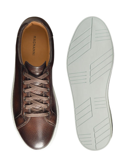 Magnanni Leve in Brown deerskin leather sneaker with its sole displayed next to it.