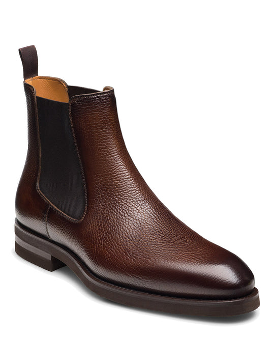 The Magnanni Lonny in Tumbled Tabaco is a men’s Chelsea boot crafted from full-grain leather with a rounded toe, black elastic side panels, and a back pull tab—luxury footwear shown on a white background.