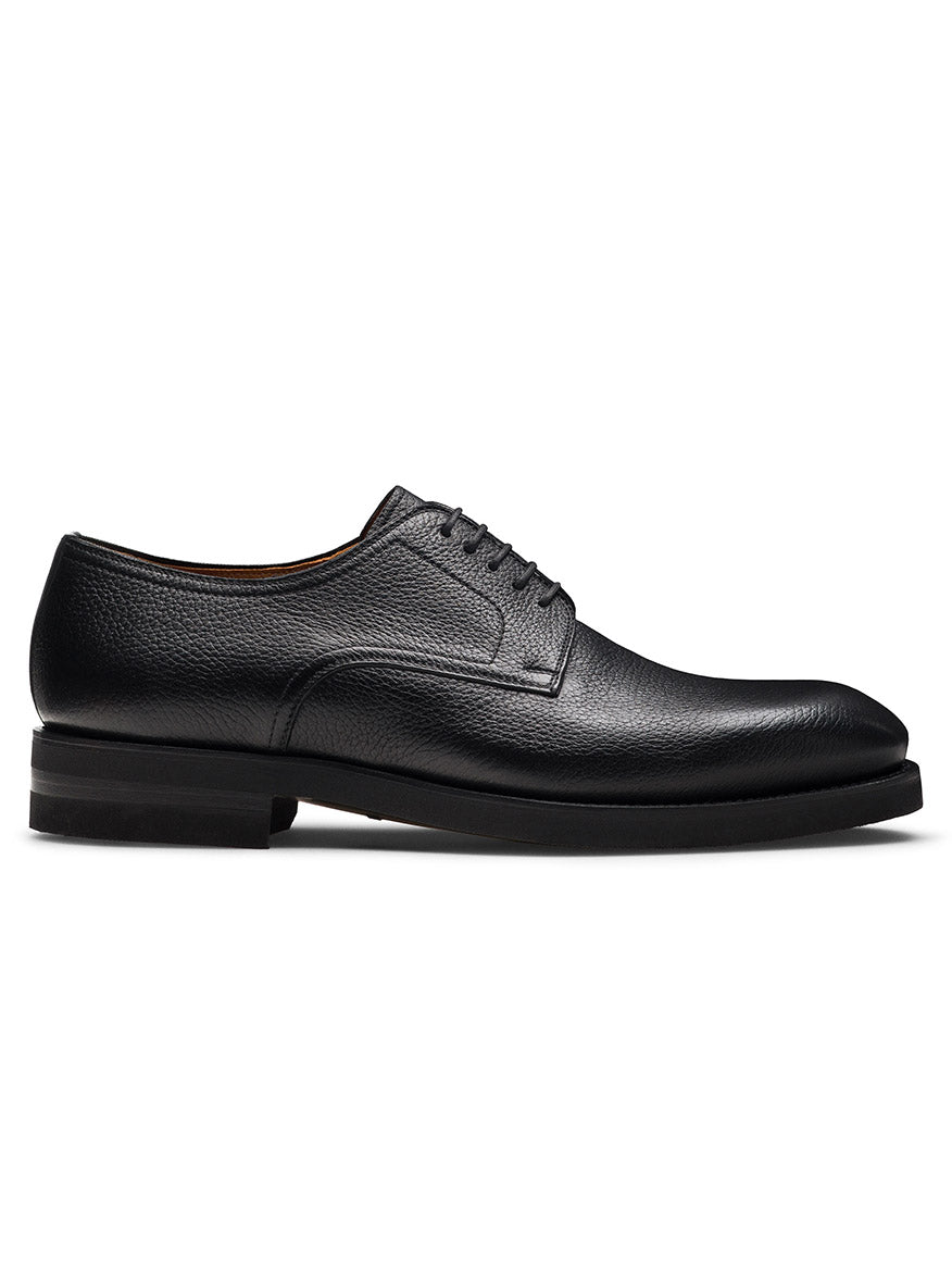 The Magnanni Melich V in Tumbled Black is a men’s black leather lace-up Derby shoe with a low heel and textured finish, ideal for smart-casual style, shown in side profile on a white background.