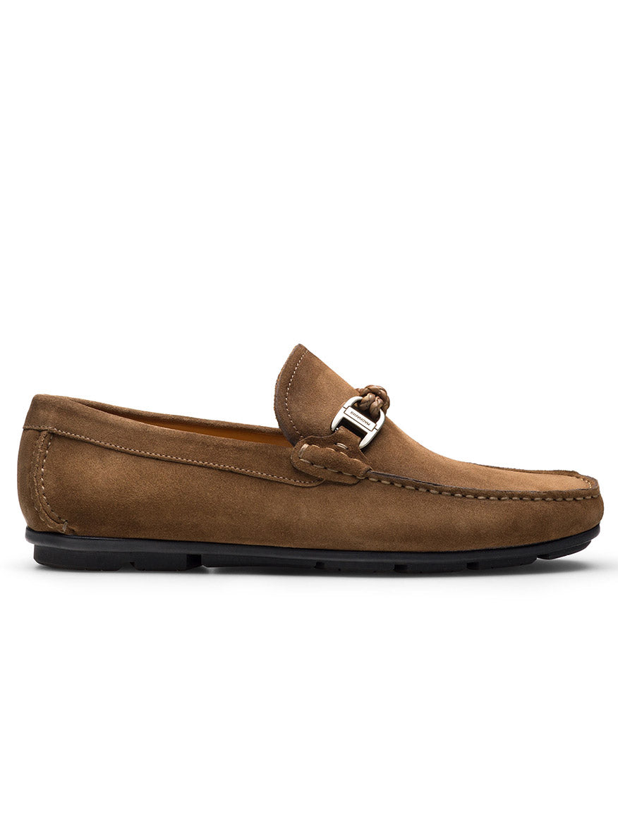 The Magnanni Monterey Braid Bit in Taupe Suede is a brown suede driving loafer with a black sole, decorative buckle, and visible side stitching. It features leather lining for comfort, blending elegance with casual style.