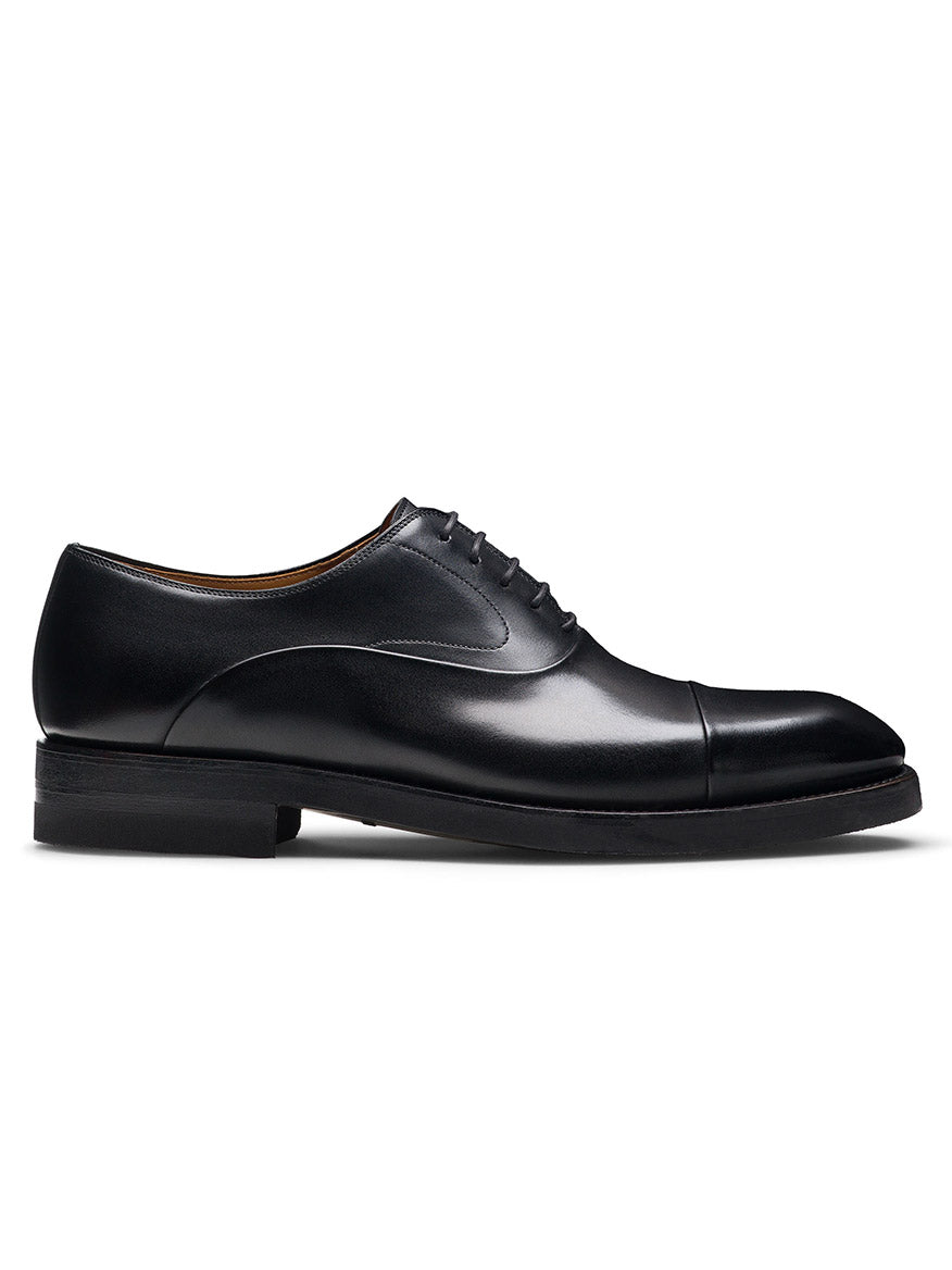The Magnanni Omega in Black, a cap toe Oxford shoe made from premium calfskin leather with laces, showcases timeless elegance in its side profile against a plain white background.