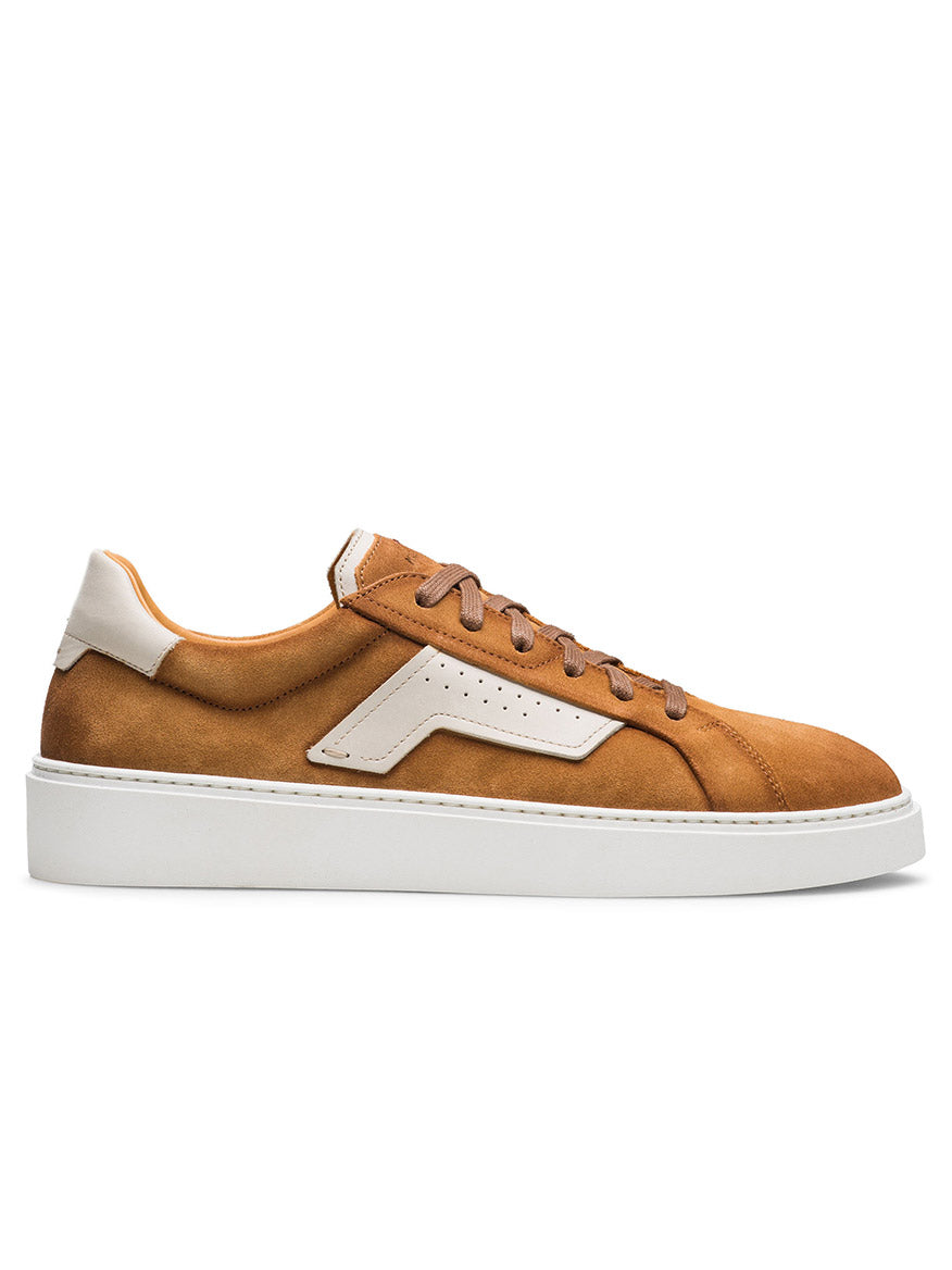 The Magnanni Phoenix in Segale Suede & Cream is a brown low-top sneaker featuring white accents, white laces, a perforated side vent, and a thick white sole—an elevated classic shown in side profile on a plain background.