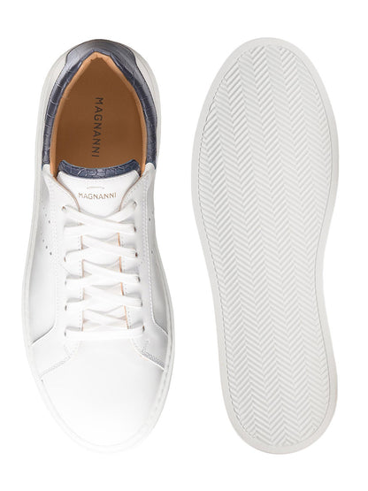 The Magnanni Reina III in White/Navy sneakers, boasting both style and quality, are a must-have pair of white sneakers with a striking blue sole.