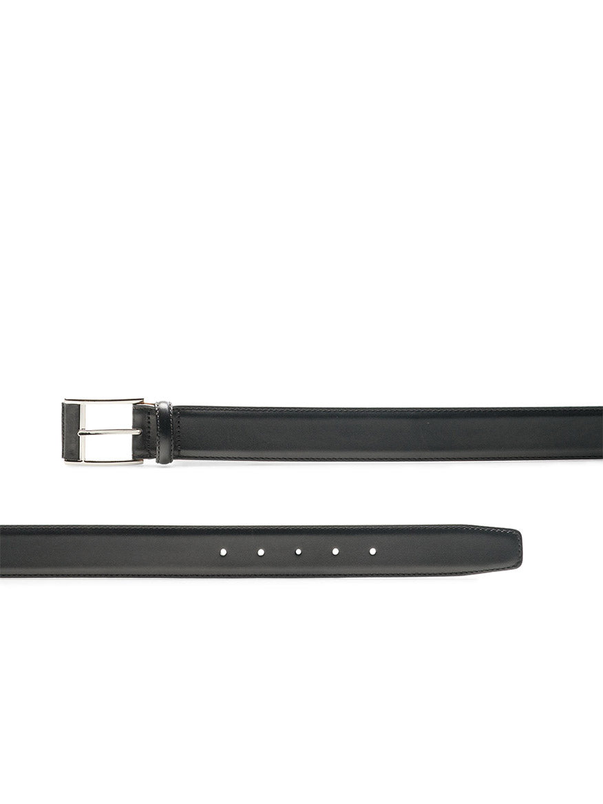 The Magnanni Velaz Belt in Black is crafted from premium calfskin leather with a silver rectangular buckle and visible adjustment holes. Expertly made in Spain, it's laid flat to showcase its sleek, timeless appeal.