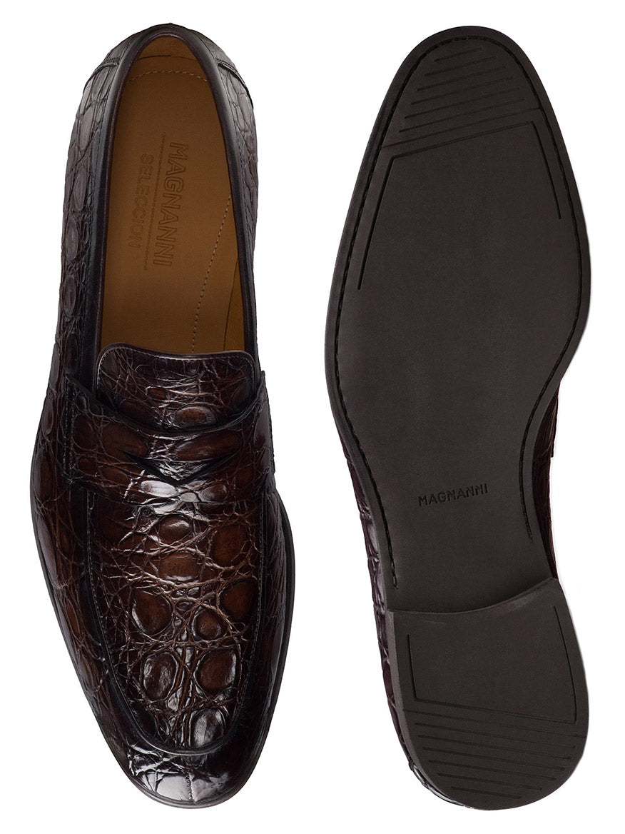 A pair of Magnanni Vicente Croc in Brown men's leather dress shoes are displayed, featuring a unique crocodile pattern; one shoe is shown from the top and the other from the sole.