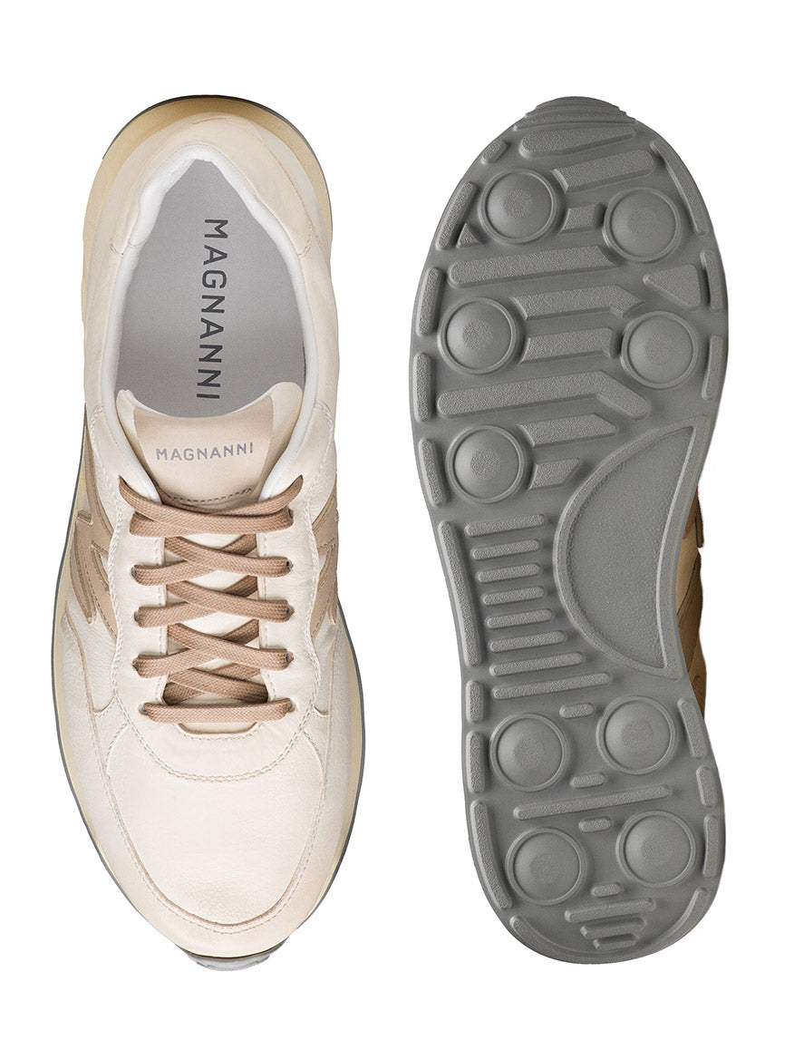 Discover the top and bottom view of the Magnanni Yoki in White/Cream, featuring a rubber athletic sole. The retro sneaker's timeless look is finished with the brand's name elegantly displayed on the insole.
