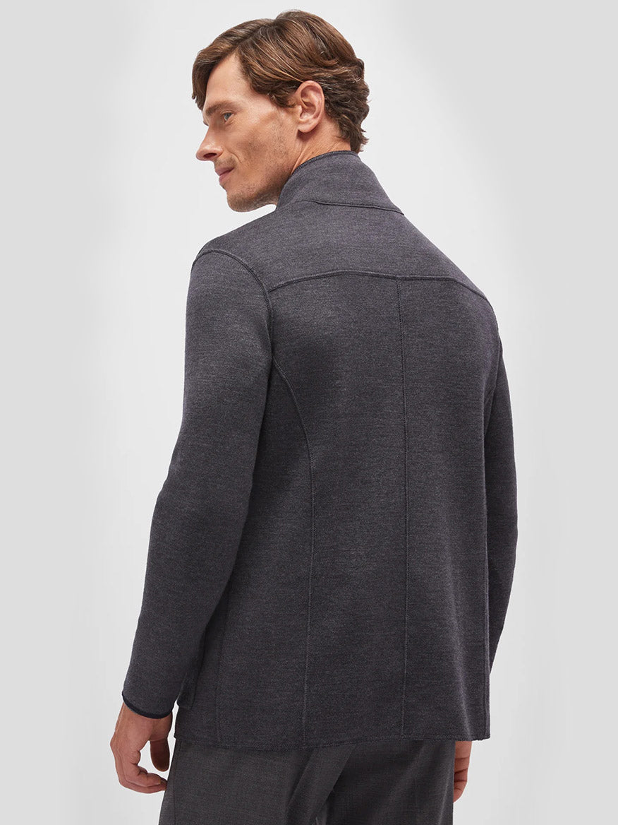 A man is shown from the back wearing a grey Maurizio Baldassari Jamaica Reversible Wool Swacket in Navy/Charcoal, looking over his left shoulder. The background is plain white.