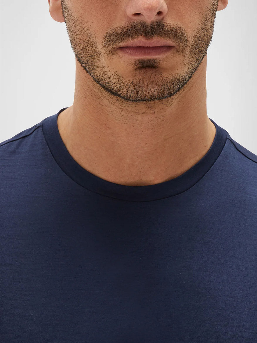 Close-up of a man wearing a Maurizio Baldassari Linate Technmerino Short Sleeve T-Shirt in Blue Nights, focusing on the neckline and lower half of his face.