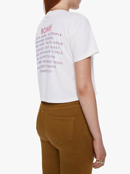 Rear view of a woman wearing a Mother Denim The Grab Bag Crop in Rebel Rebel tee from the David Bowie capsule collection, paired with brown trousers.