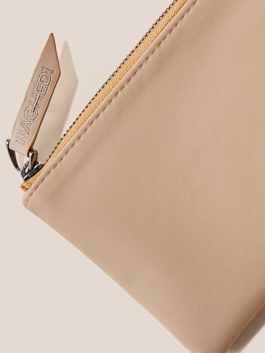 Naghedi Laguna Crossbody in Solid Camel with a gold-tone zipper and branded pull tag.