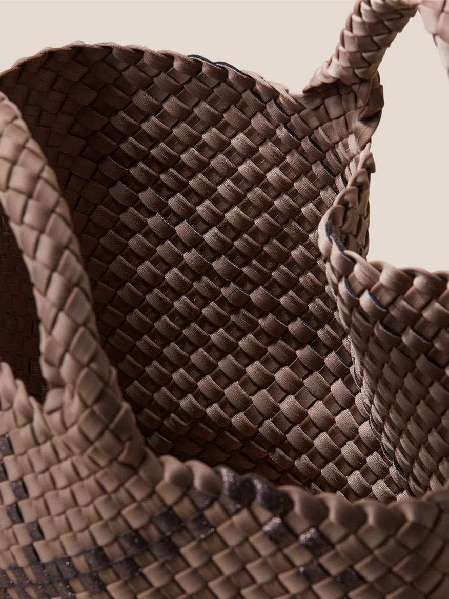 Close-up of a Naghedi St. Barths Medium Tote in Plaid Mojave, showing intricate interlacing detail and a sturdy handle.