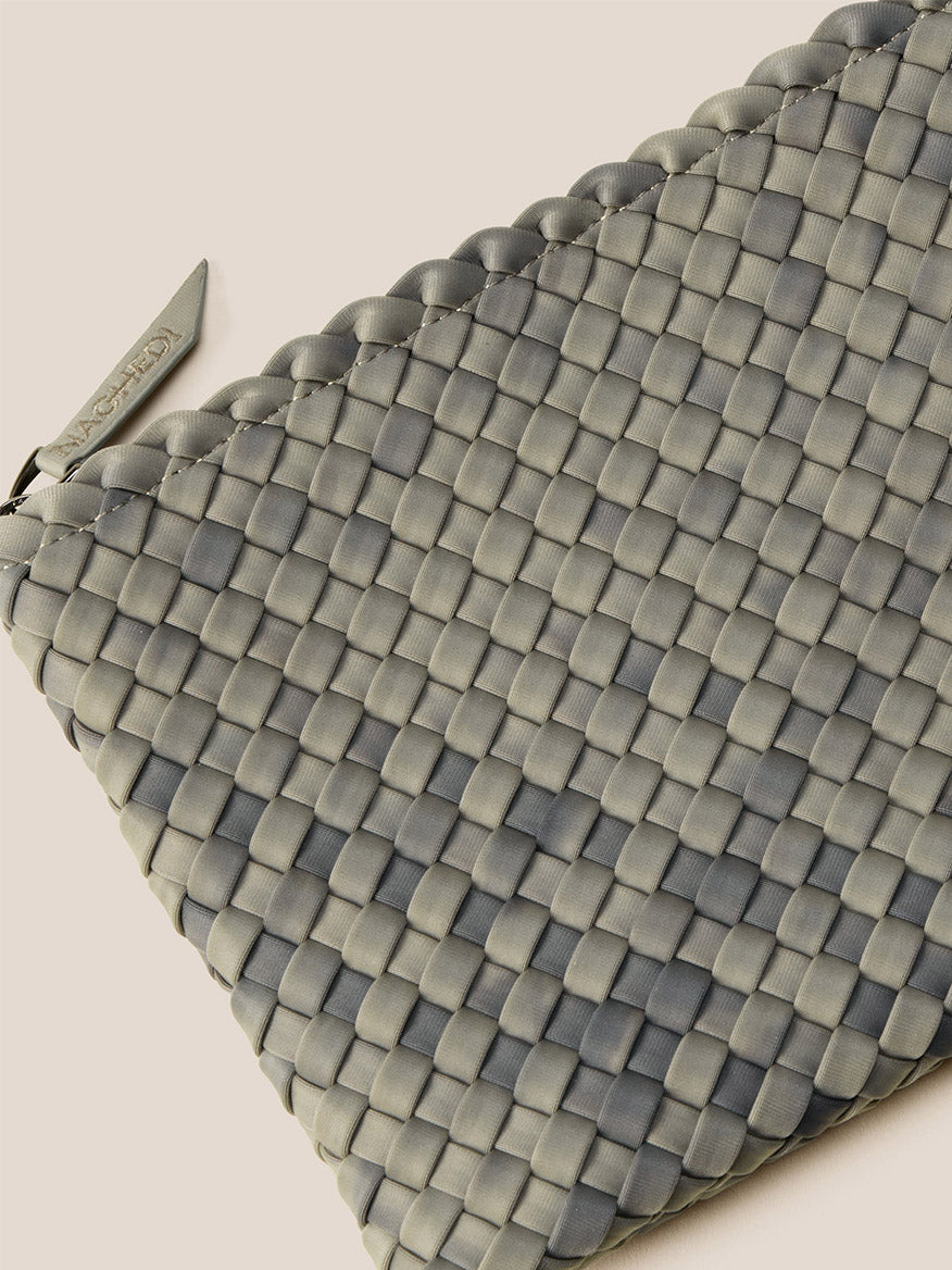 This handwoven neoprene pouch, inspired by the Naghedi St. Barths Medium Tote in Watercolor Neptune, is crafted for everyday functionality. It boasts a textured checkered pattern in gray and is fastened with a smooth zipper closure.