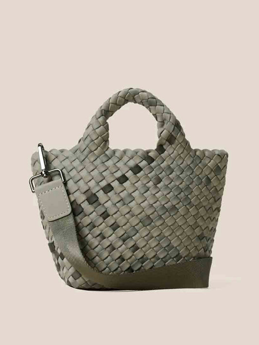 The Naghedi St. Barths Petit Tote in Watercolor Neptune is a green handwoven neoprene handbag that includes a detachable crossbody strap and two sturdy handles, set against a plain background.