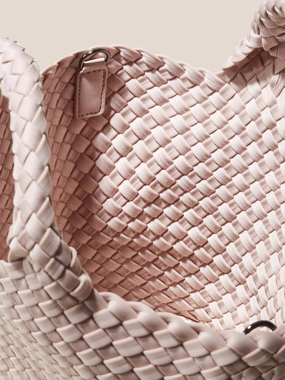 Close-up of a Naghedi St. Barths Small Tote in Solid Shell Pink with a braided handle.