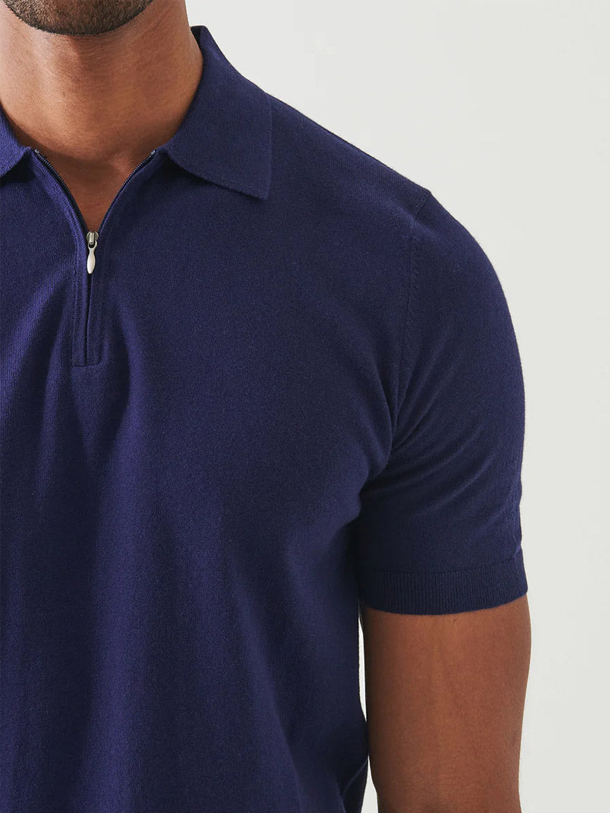 A person wears the Patrick Assaraf Cotton Cashmere Quarter Zip Polo in Navy, short-sleeved and shown from shoulders to mid-torso against a plain background.