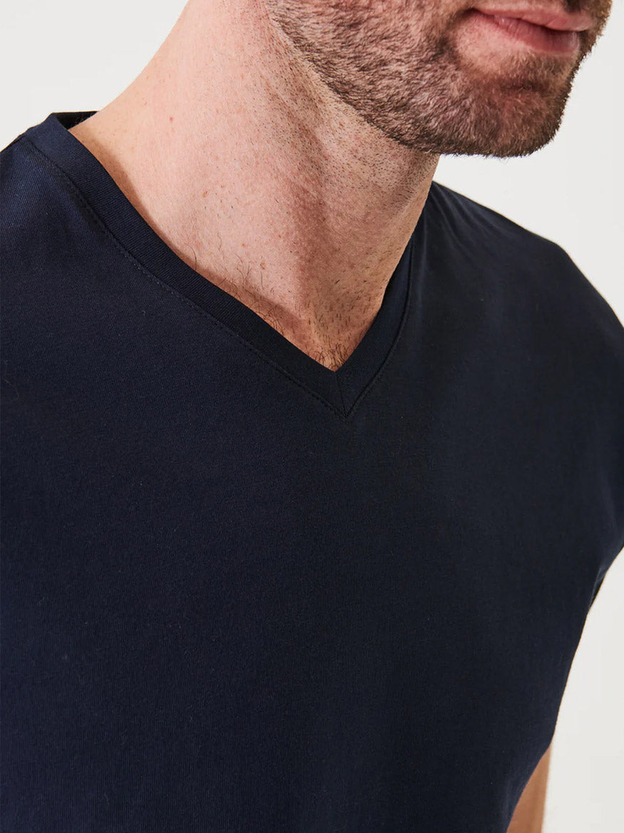 A close-up of a man wearing the Patrick Assaraf Pima Cotton Stretch V-Neck T-Shirt in Midnight, highlighting his neck, jawline, and upper chest—a subtle nod to timeless style.