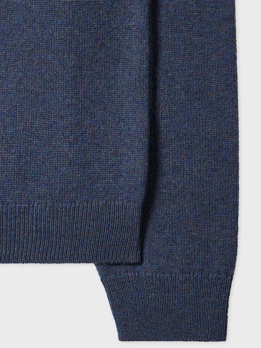 Close-up of the Paul Smith Indigo Merino Wool Crew Neck Sweater in soft knit, showcasing its ribbed hem and cuffs against a plain background.