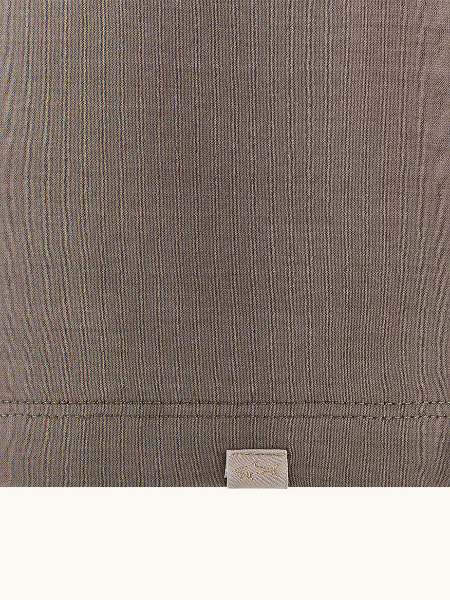 Close-up of the Paul & Shark Polo Jersey Shirt With Linen Details in Morel, showing brown double mercerised cotton fabric, visible stitching near the bottom, and a small beige tag below the seam.