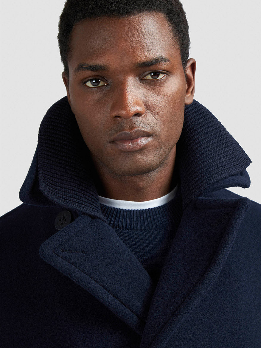 A man wears the Paul & Shark Peacoat in Wool & Cashmere in Navy with a wide collar over a navy sweater and white shirt, looking at the camera against a plain background.