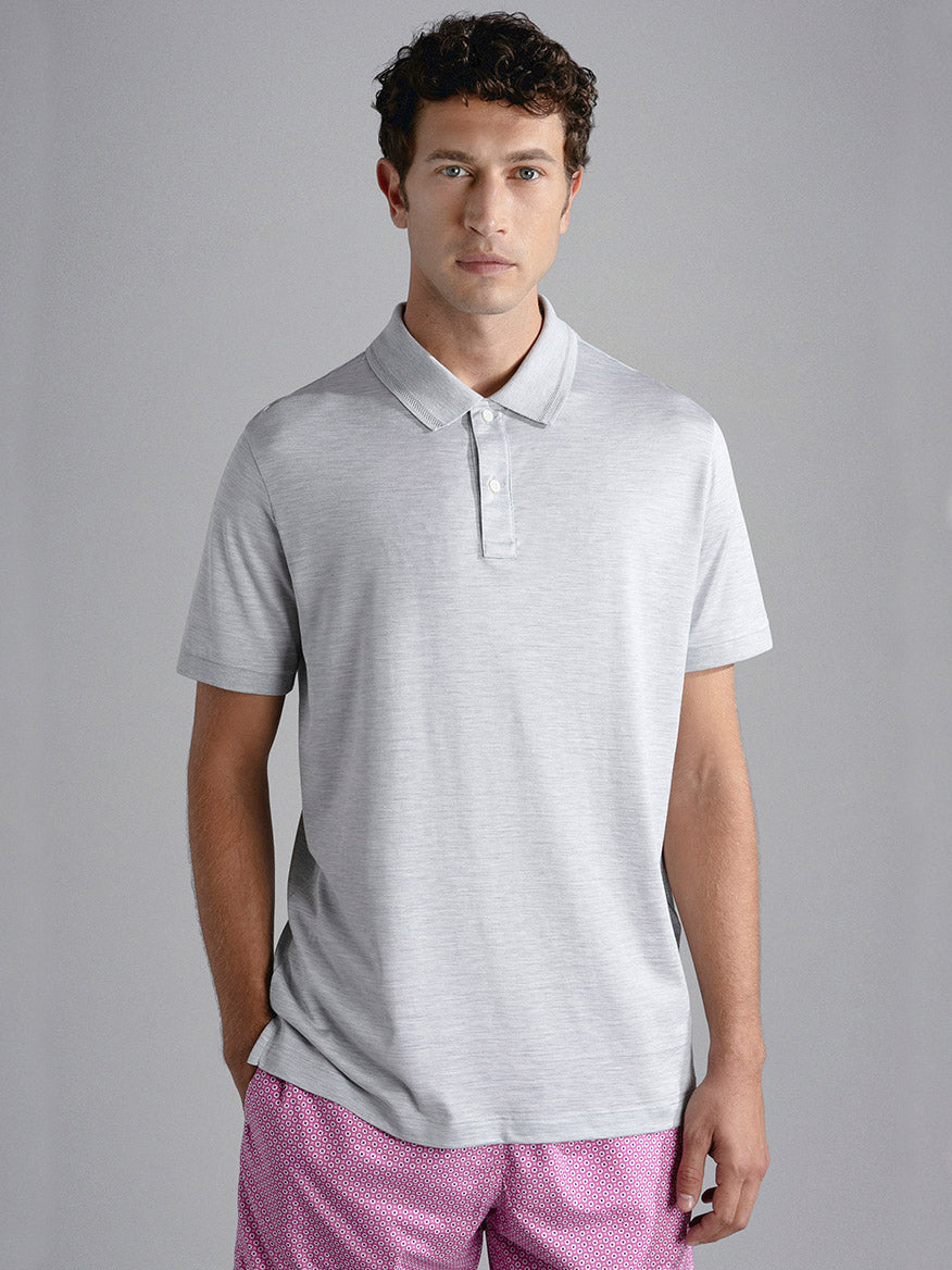 Man wearing a Paul & Shark Cotton & Silk Polo in Medium Grey and patterned shorts standing against a neutral background.
