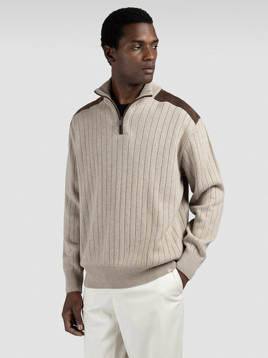 A man wears a Paul & Shark Quarter Zip Sweater With Suede Details in Natural and light pants, standing against a plain background.