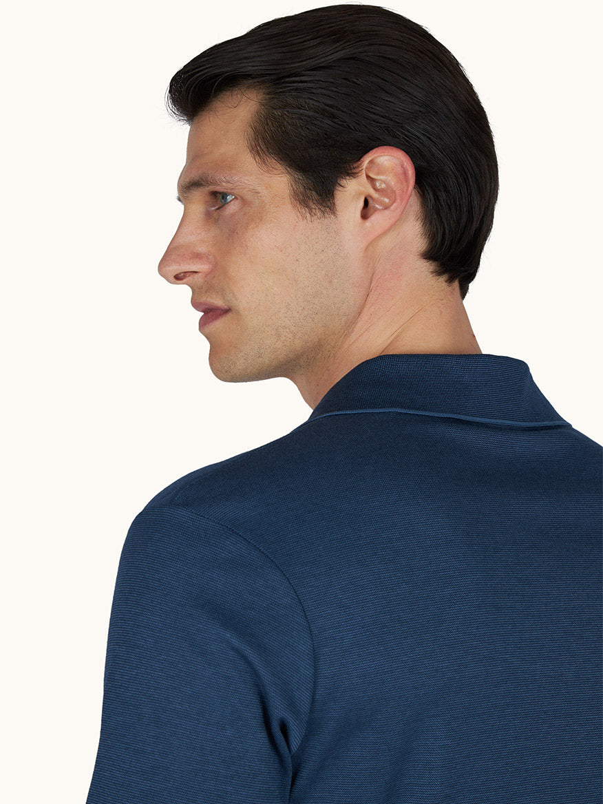 A man with short dark hair, wearing a Paul & Shark X-Soft Open‑Collar Polo Shirt in Vintage Indigo, is shown from the side and back against a plain background.