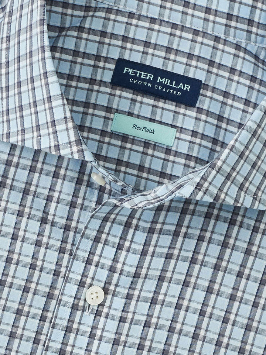A close-up of the Peter Millar Abetone Cotton Sport Shirt in Blue Frost, highlighting its blue and white checks, tailored fit collar, buttons, and brand label with Flex Finish detailing.