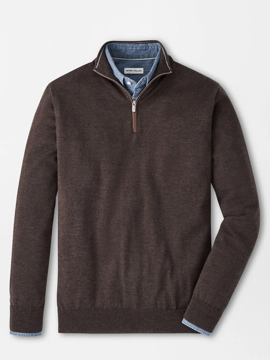 The Peter Millar Autumn Crest Suede Trim Quarter-Zip in French Press is layered over a blue button-down shirt, both displayed flat on a white background.