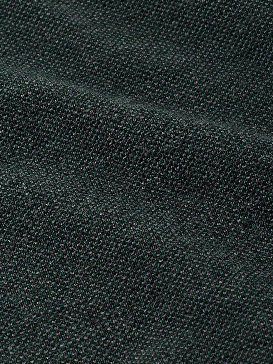 Close-up of a dark green Peter Millar Blair Birdseye Quarter-Zip Sweater in Pine Brook, featuring a finely textured birdseye stitch pattern.