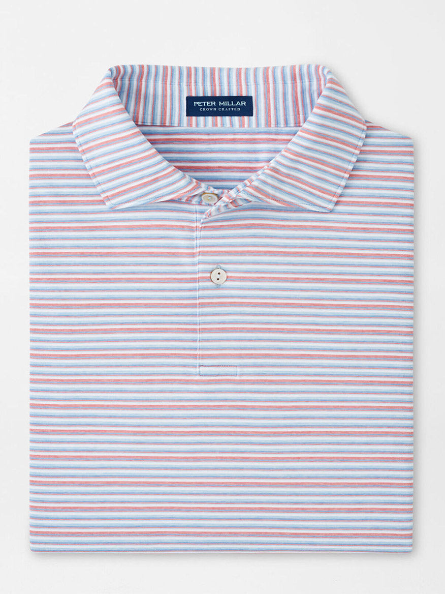The Peter Millar Cadence Performance Jersey Polo in Blue Frost is neatly folded, features horizontal white, blue, and light red stripes, a buttoned collar, and offers four-way stretch for extra comfort.