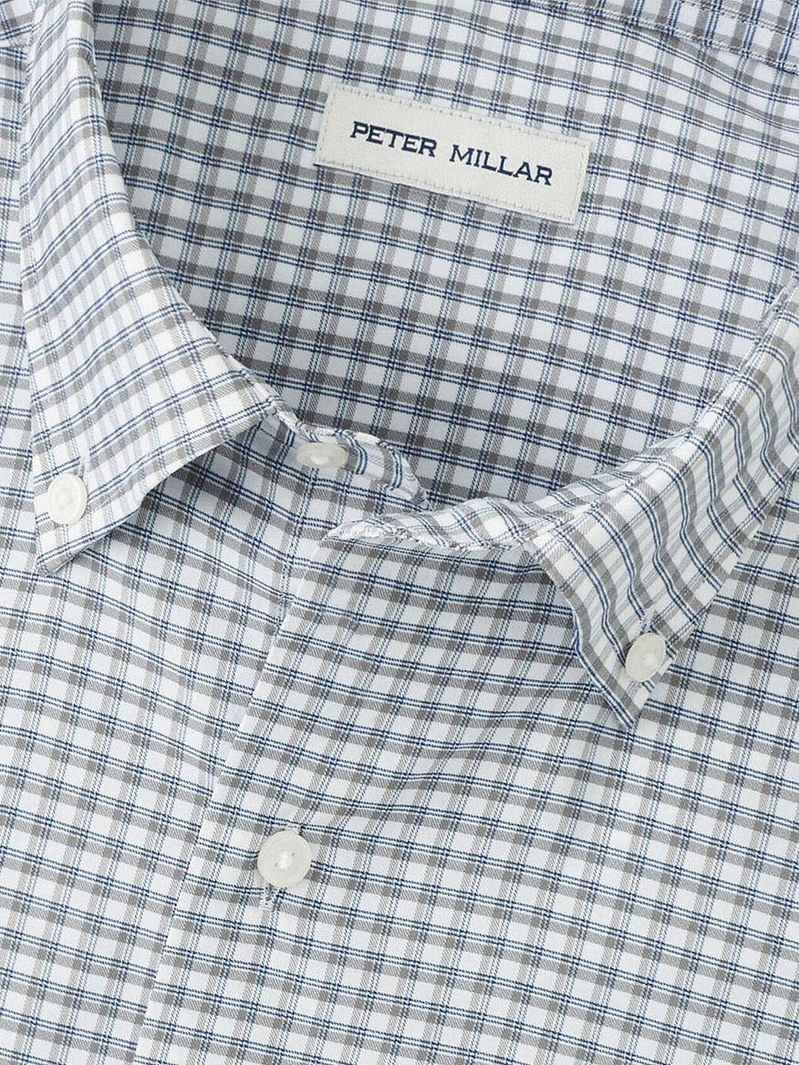 Close-up of the Peter Millar Cashiers Performance Twill Sport Shirt in Oslo Grey, featuring a blue and white checkered pattern, moisture-wicking comfort, and a classic fit.