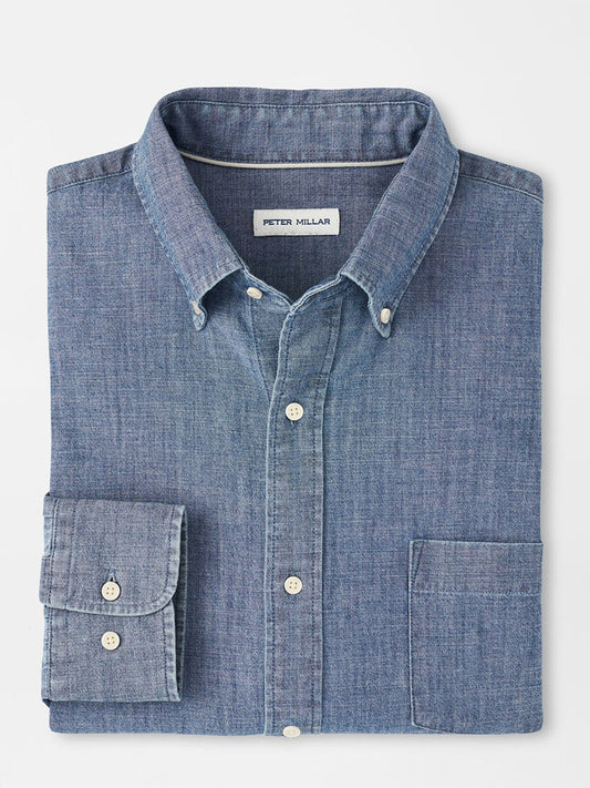 The Peter Millar Tamworth Chambray Cotton-Stretch Sport Shirt features a folded blue design with white buttons, a visible chest pocket, and "Peter Millar" label inside the collar—a classic casual style for any occasion.