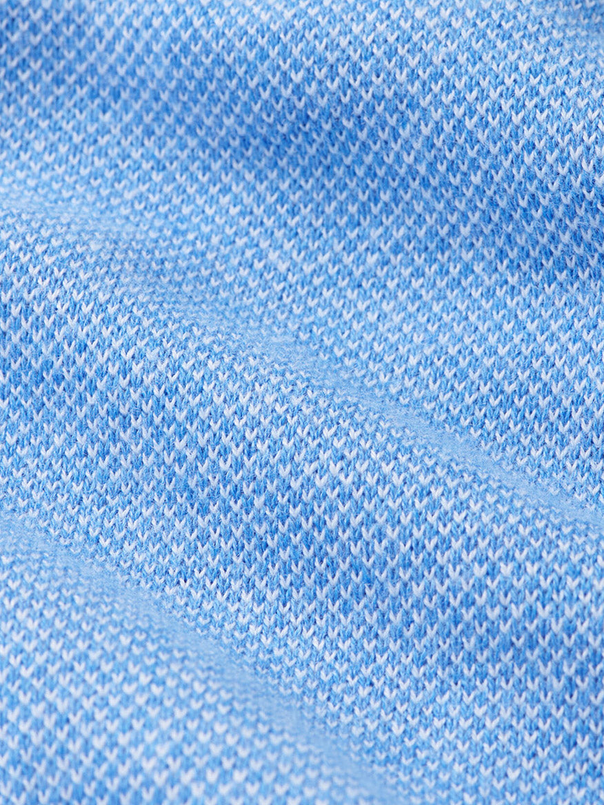 Close-up of the Peter Millar Coolspun Lite Birdseye Quarter Zip Sweater in Bluebird, featuring textured, wavy light blue knit with small patterns and moisture-wicking properties.