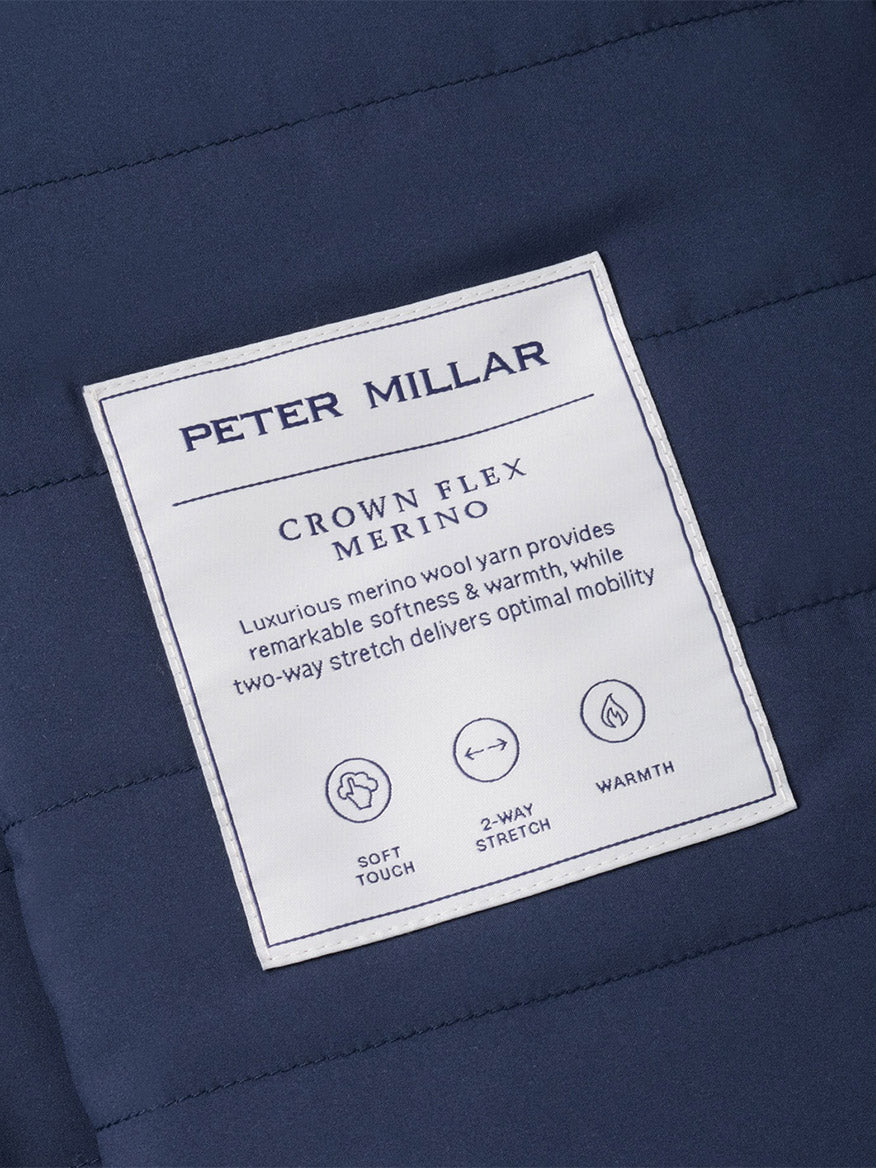 Peter Millar Crown Flex Merino Vest in Atlantic Blue, a quilted vest featuring an insulated interior tag with fabric details and icons for soft touch, two-way stretch, and warmth.