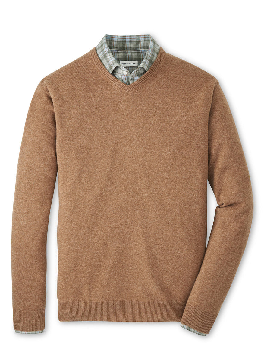 The Peter Millar Crown Heritage Cashmere V-Neck Sweater in British Tan is styled over a green and white plaid collared shirt, both neatly displayed on a white background.