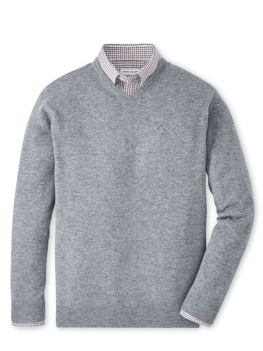 The Peter Millar Crown Heritage Cashmere V-Neck Sweater in Oslo Grey is layered over a collared, checkered shirt and displayed flat against a white background.
