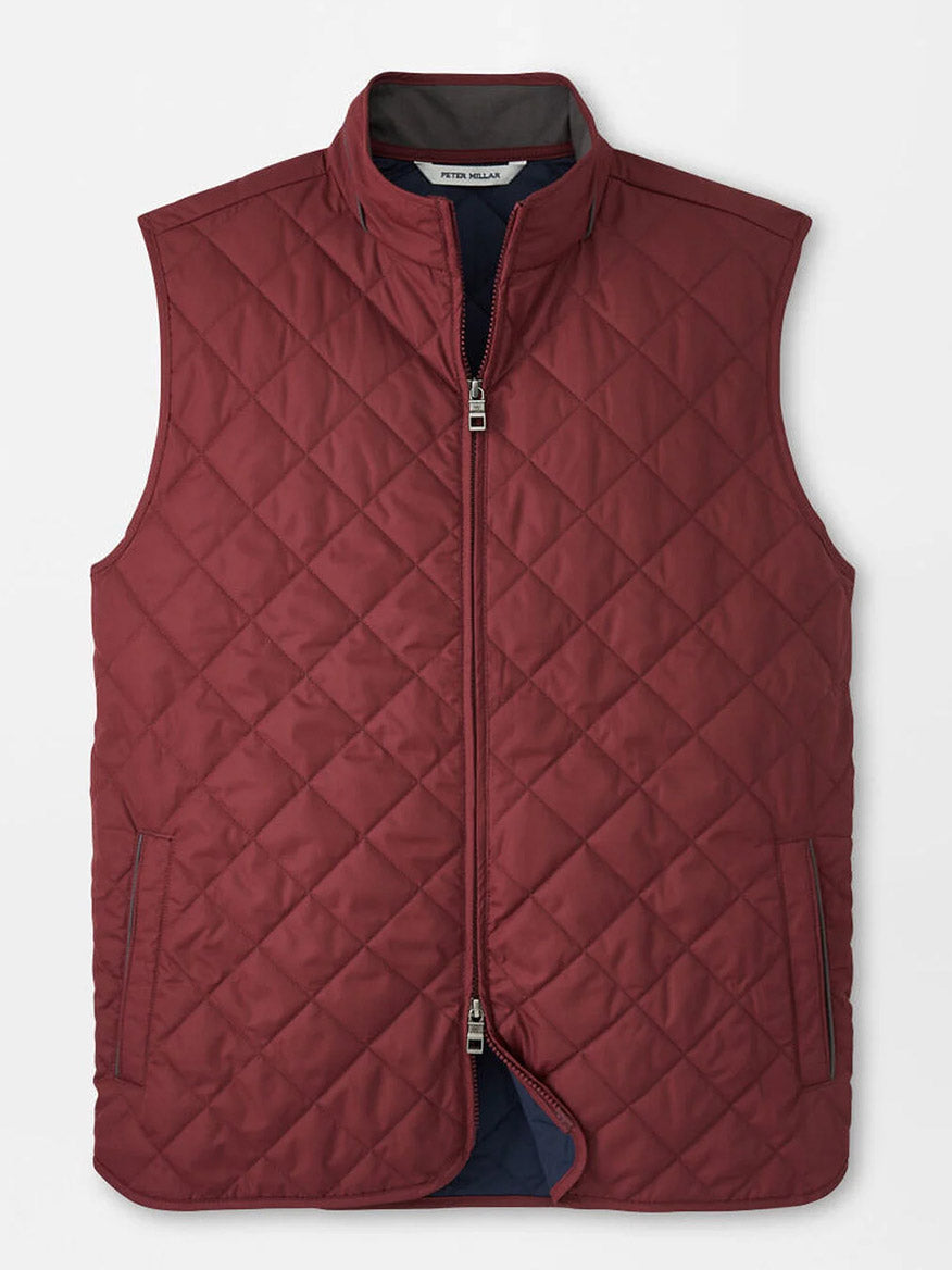The Peter Millar Essex Vest in Autumn Foliage is a sleeveless maroon quilted vest with a front zipper, two side pockets, and a standing collar, shown flat on a white background.