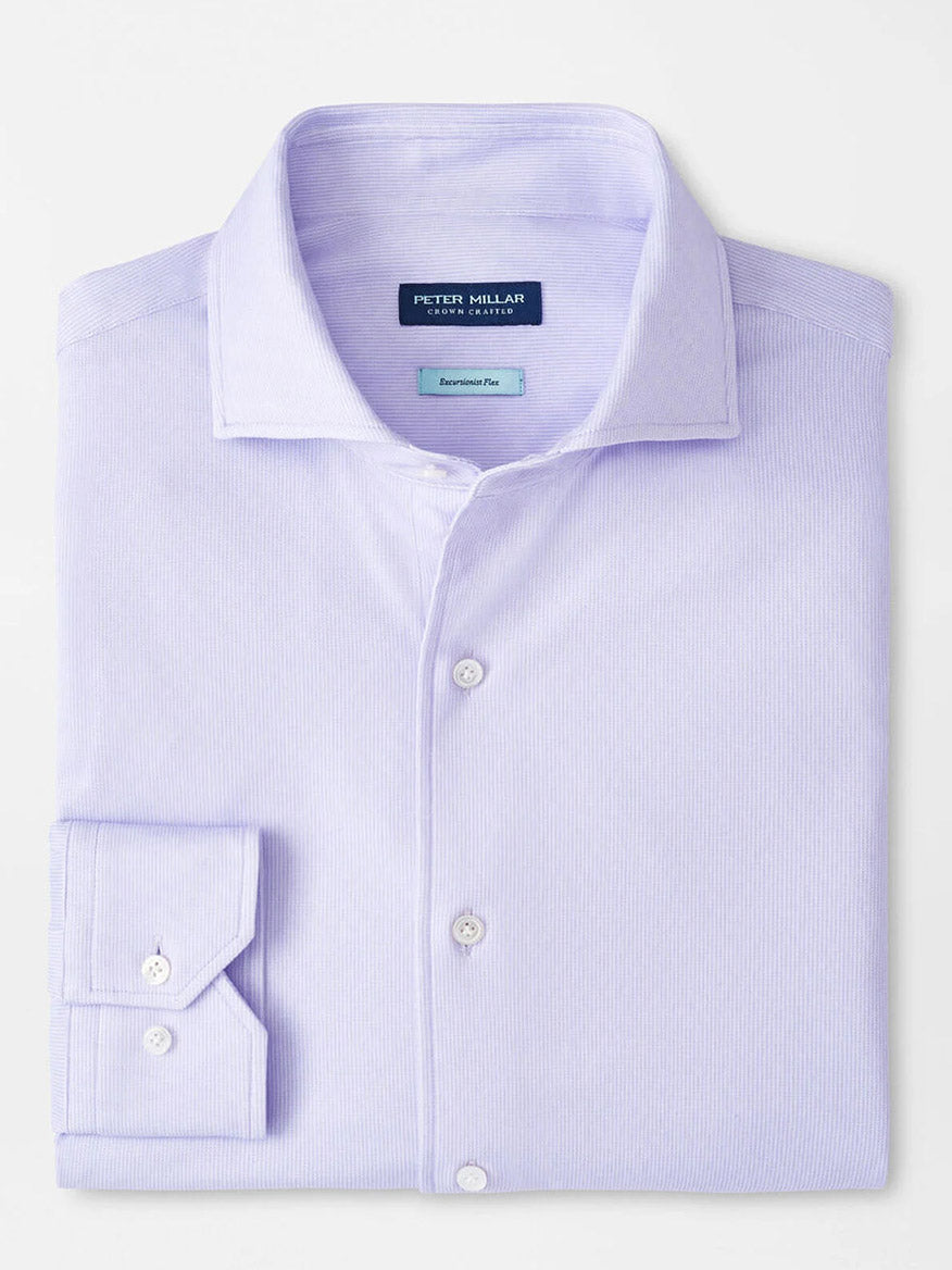 A Peter Millar Excursionist Flex Micro Print Shirt in Wisteria, neatly folded, features a tailored fit, spread collar, white buttons, and the "Peter Millar" label inside the collar.
