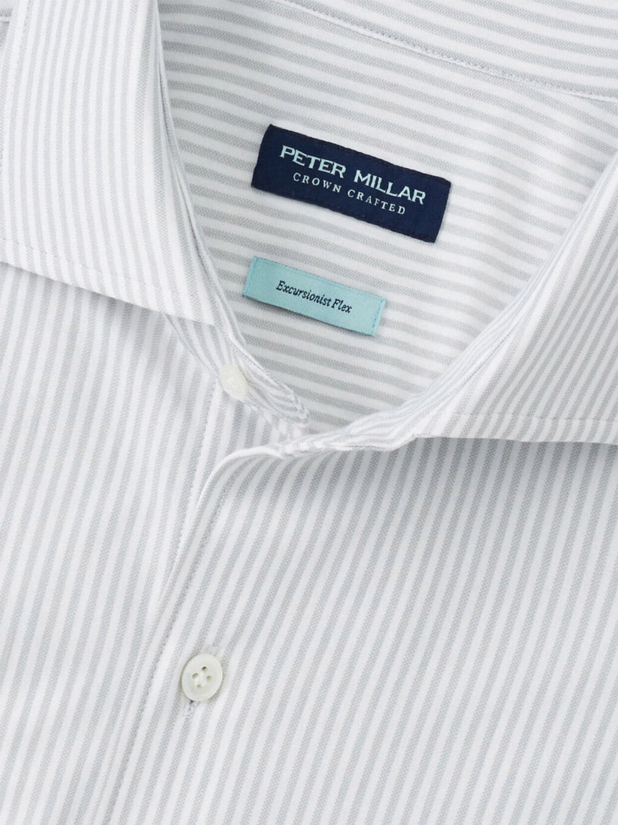 Close-up of the Peter Millar Excursionist Flex Stripe Sport Shirt in British Grey, featuring light grey stripes on white, crafted from wrinkle-resistant cotton-stretch fabric and finished with white buttons.
