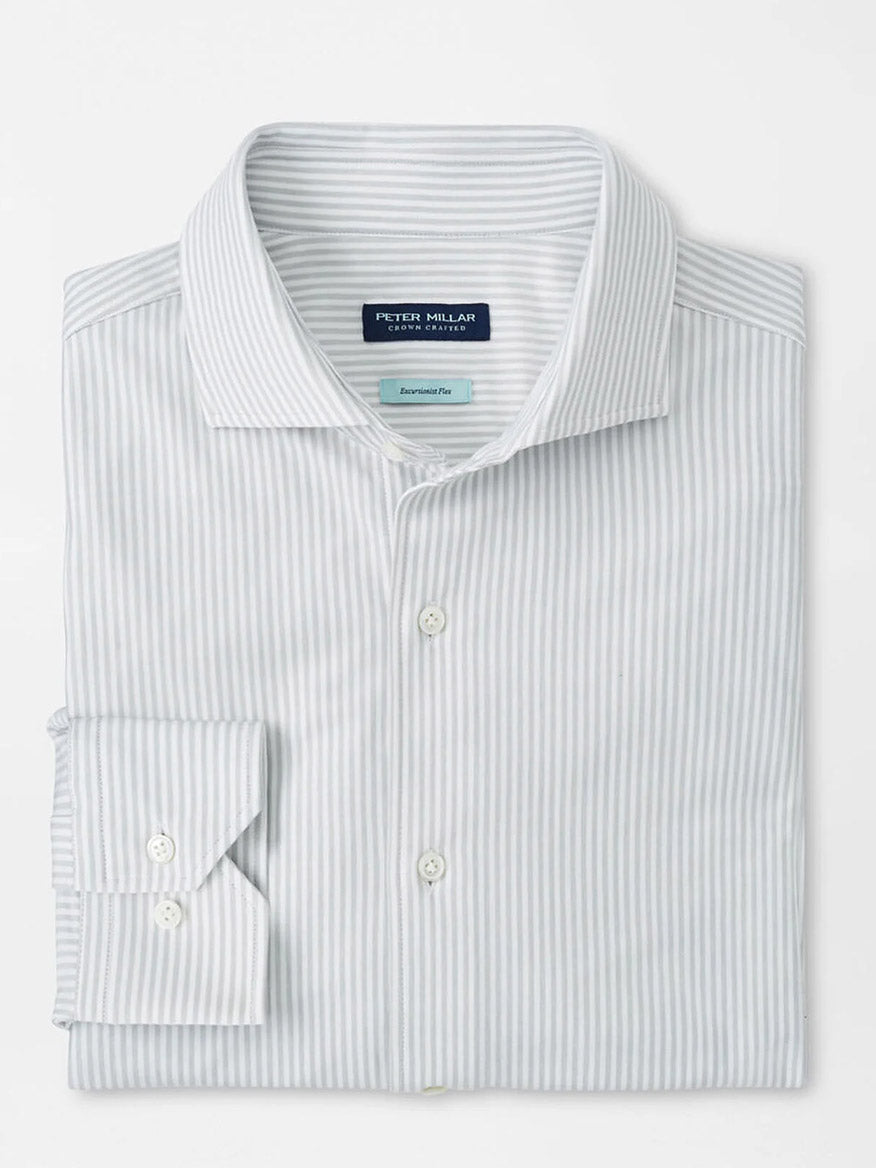 The Peter Millar Excursionist Flex Stripe Sport Shirt in British Grey is a long-sleeve, white shirt with light gray stripes, made from wrinkle-resistant cotton-stretch fabric and finished with a buttoned collar and cuffs.