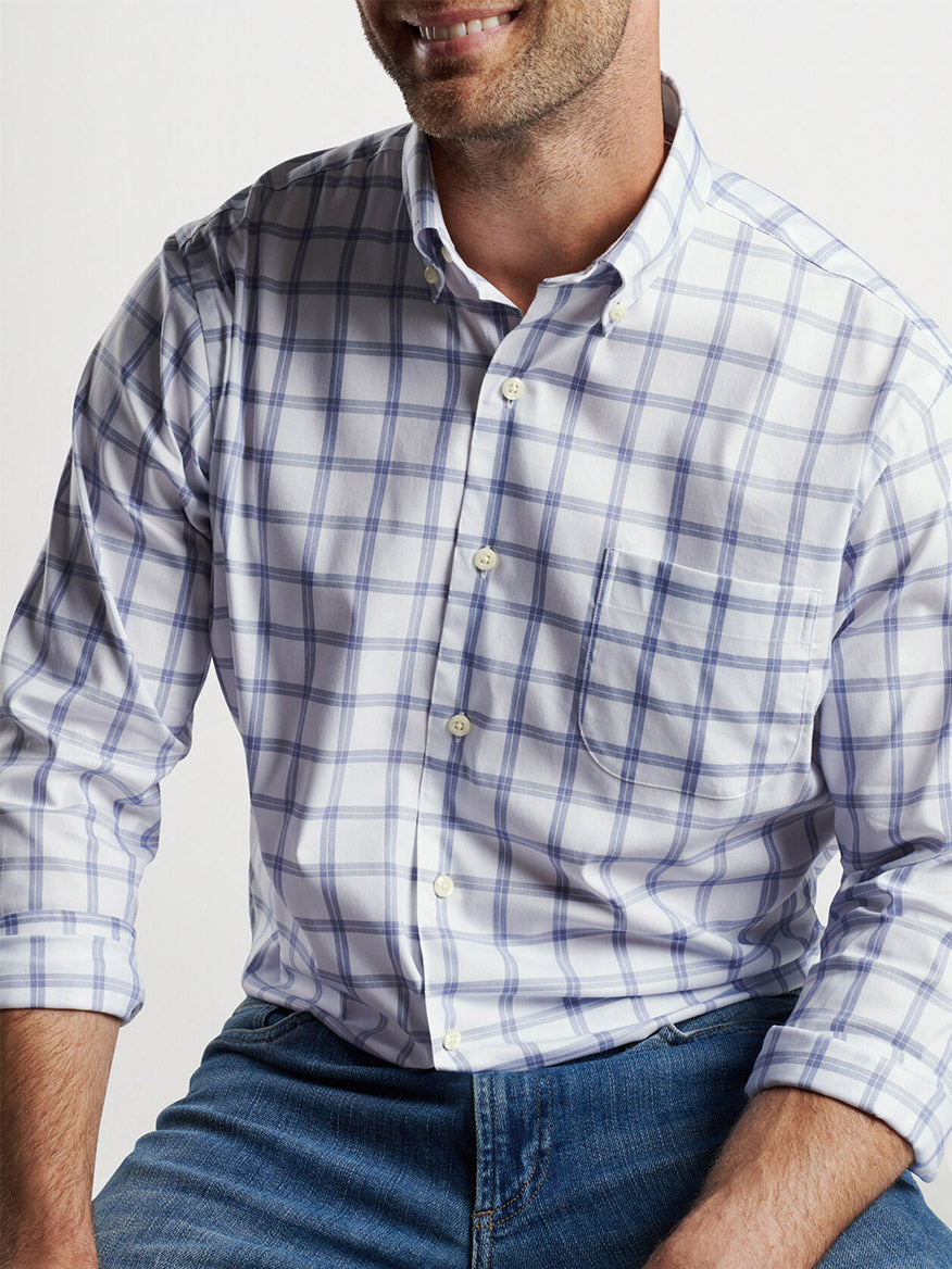 Man wearing a Peter Millar Gorham Crown Lite Cotton-Stretch sport shirt in white plaid and jeans, partial view from mid-torso up, smiling off-camera.