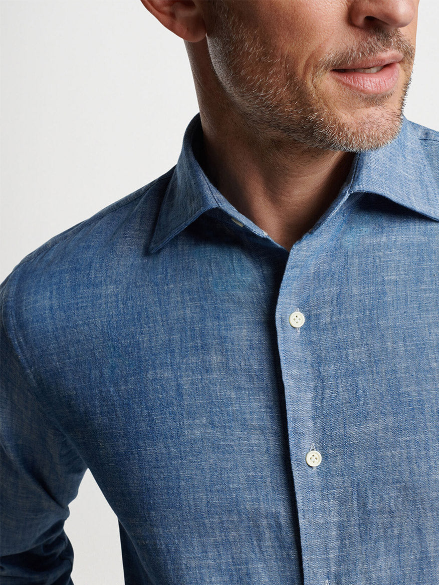 Close-up of a man in a Peter Millar Japanese Selvedge Sport Shirt in Light Chambray with collar details visible.