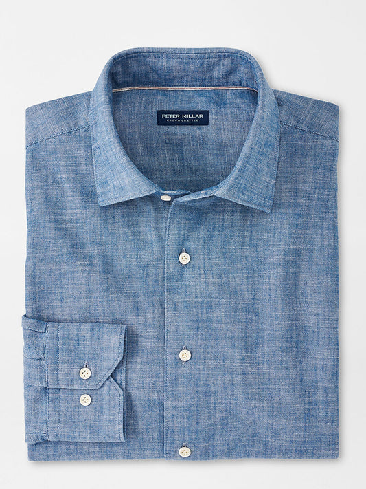 A neatly folded Light Chambray Peter Millar Japanese Selvedge Sport Shirt displayed on a white background.
