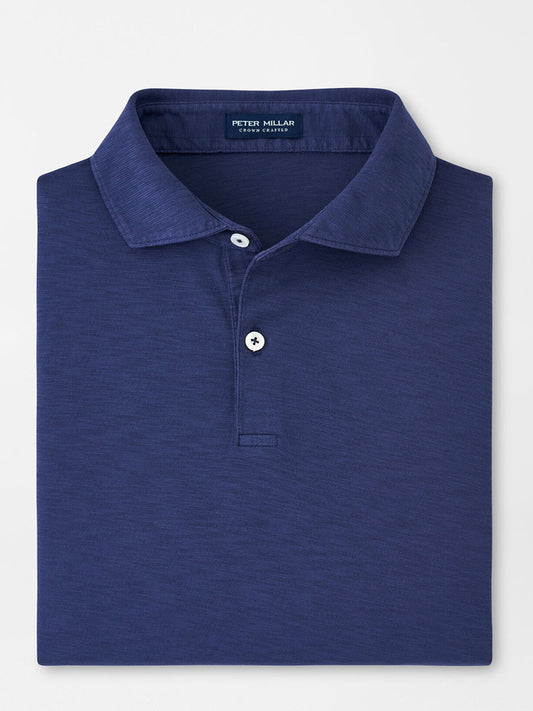 Navy blue Peter Millar Journeyman Short Sleeve Polo with a tailored fit, visible collar, and top button on a flat surface.
